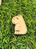An image of a hand drawn wooden capybara pin badge