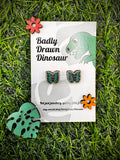 Denis The Dilophosaurus - hand drawn laser cut wooden stud earrings.